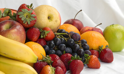 Assorted Fruits Clustered on White Surface