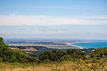 A view of Pett Level from the Firehills near Fairlight in East Sussex. Wind Turbines and the Kent...