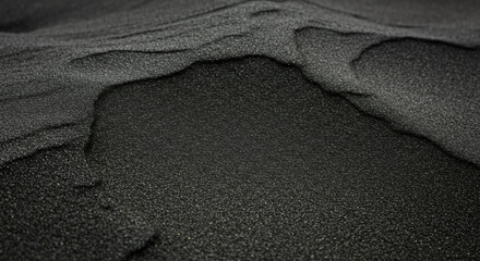Close-up view of dark gray granular material.