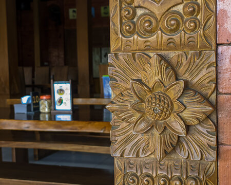 Carved wooden ornaments on an old Javanese ethnic building, hand-crafted artwork.