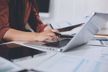 Fototapeta premium Portrait of young Hispanic professional business woman standing in office. Happy female company executive, smiling businesswoman entrepreneur corporate leader manager looking at camera using tablet