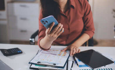 Closeup image of a businesswoman using mobile phone in office