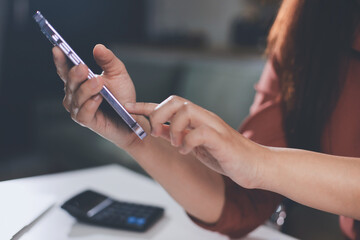 Closeup image of a businesswoman using mobile phone in office