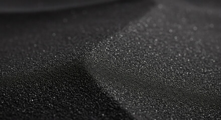 Close-up view of water droplets on a dark surface.