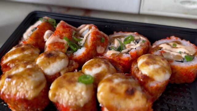 sushi on a tray with sauce
