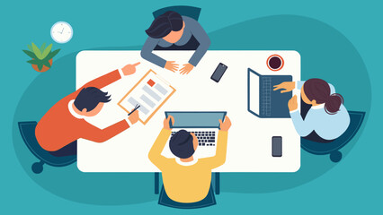 Top view of a team brainstorming around a table with laptops and documents; ideal for website banners or presentations.