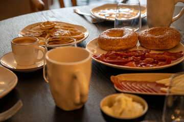 A table with plates of food and a cup of coffee. Scene is casual and inviting