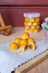 Sweet pineapple jam filling on nastar cookies on a wooden board