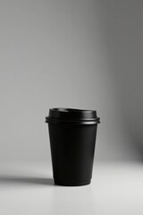 A Single Black Disposable Coffee Cup with Lid on a Plain Background