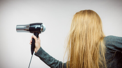 Woman holding hairdryer