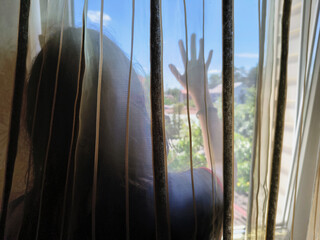 girl near the window holds her hand on the glass. Drawings on wet windows. man behind the glass....