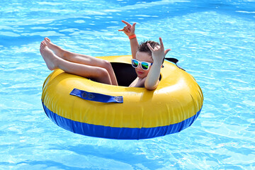 Portrait of happy boy in the swimming pool