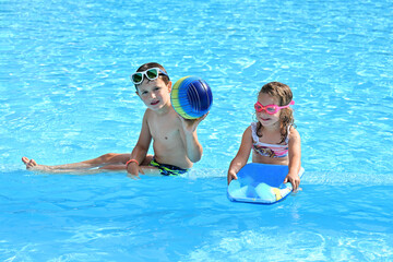 Happy boy and girl in the swimming pool