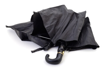 Broken black umbrella isolated.