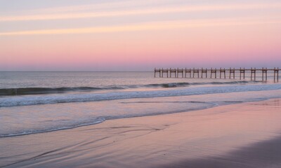 Pastel sunset over ocean pier