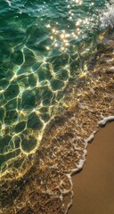 Crystal-clear turquoise water washes onto a sandy beach, sun reflecting