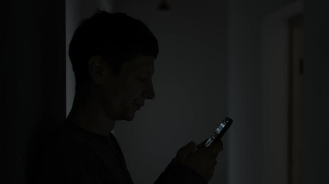 Emotions after breakup. Young man scrolling through his ex girlfriend feed feeling sadness and pain of loss. Broken heart and loneliness.