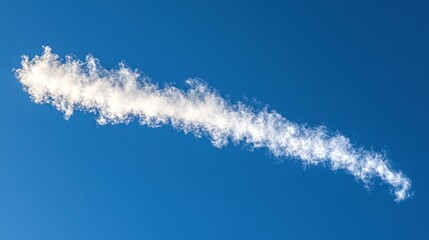 Wispy white cloud streak against a deep blue sky