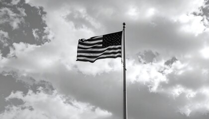 American flag waving in cloudy sky