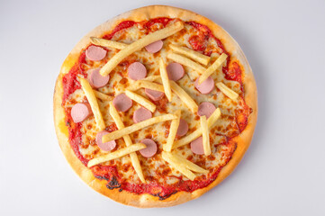 Italian pizza with fresh tomato sauce, melted mozzarella, sausages, crispy fries, and anchovies, captured from above on a white background. 