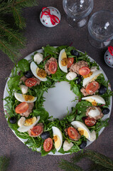 Wreath-shaped salad with tuna, egg, mozzarella and olives, top view
