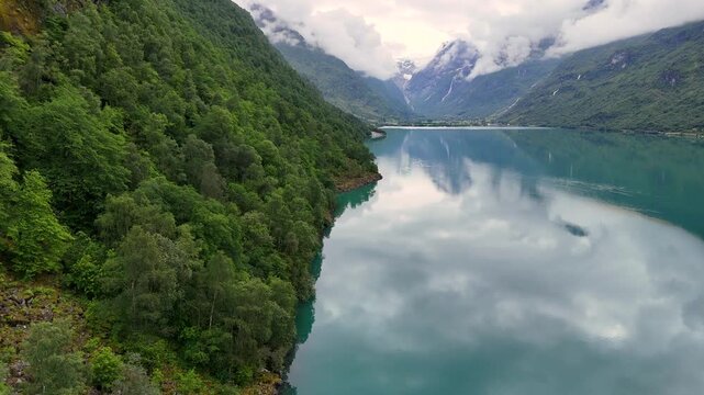 Aerial view of the calm lake Oldevatnet framed by lush steep mountainsides in the Oldedalen valley