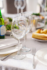 Elegant dining setup with glasses and delicious food on table