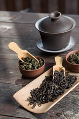 Chinese tea, making tea in a traditional, in a small cups and teapot over dark background