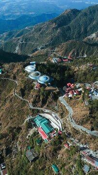 Aerial View of Mussoorie Hill Station. Dehradun district of the Indian state of Uttarakhand. Aerial Footage from Mussoorie. Mountains with blue sky and clouds in Mussoorie.