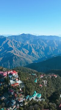 Aerial View of Mussoorie Hill Station. Dehradun district of the Indian state of Uttarakhand. Aerial Footage from Mussoorie. Mountains with blue sky and clouds in Mussoorie.
