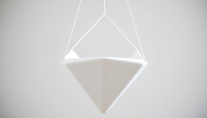 Close-up of a matte white ceramic geometric planter in the shape of a diamond, suspended by minimalist wireframe holder