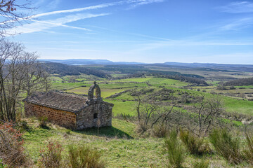 Exterior of Santa Cecilia Hermitage in Monasterio with stone walls and arch