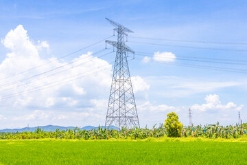 high voltage power lines on green field