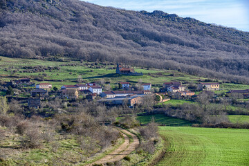 Naklejka premium Panoramic view of Villanueva de la Torre with Romanesque church on hillside