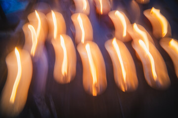 Flickering candlelight illuminates a serene gathering in the evening