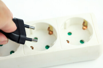 Hand connecting cable on power strip