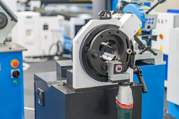 Industrial setting with focus on mechanical equipment, featuring a large cylindrical machine with...