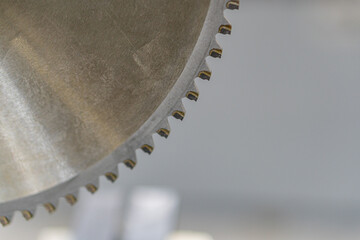 Close-up view of a worn, metallic object with teeth or serrations, possibly used in construction...