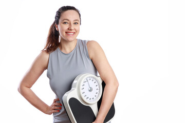Smiling woman holding bathroom scale. Healthy eating, fitness and weight loss concepts
