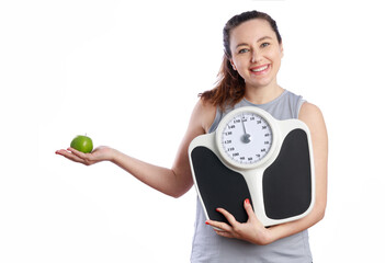 Smiling woman holding weight scale and green apple for healthy lifestyle