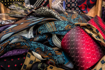 Vintage men's ties in a box, rag pattern, textile colorful background, old photo. Antique fabrics, retro fabric pattern.