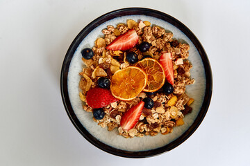 A Deliciously Healthy Breakfast Bowl Filled with Granola, Fresh Fruits, and Nuts for a Nutritious...