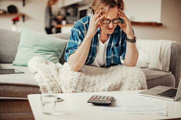 Mature man calculating and going over his bills and home finances