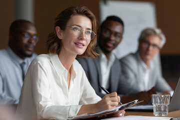 Businesswoman leading corporate meeting with team