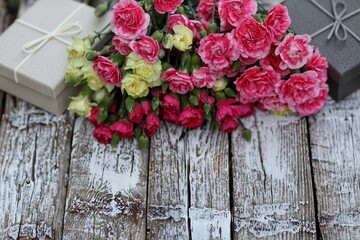 Bouquet of carnations on a wooden background, free space, top view, gift, presents, flowers, day, holiday