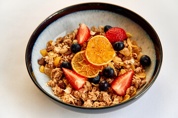 A Vibrant Bowl of Nutritious Granola Topped with Fresh Berries and Dried Fruits for a Healthy Breakfast Delight