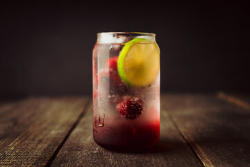 Refreshing summer cocktail with cherries and rum on the rustic background. Selective focus.