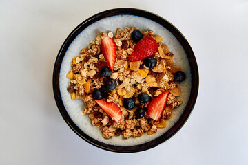 A Delicious Bowl of Granola Topped with Fresh Strawberries, Blueberries, and Dried Fruits for a Healthy Breakfast Option Full of Flavor and Nutrition