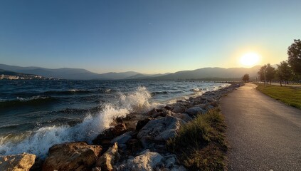 Fototapeta premium Scenic lakefront path at sunset with crashing waves