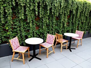 Obraz premium Outdoor bistro set with vibrant greenery backdrop
